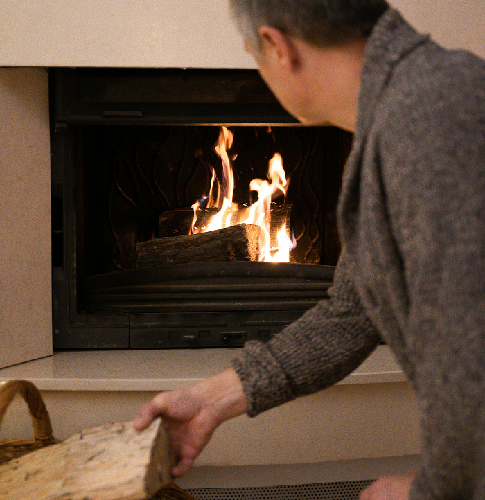 Stock Image Loading the Fireplace man loading wood into a fireplace
