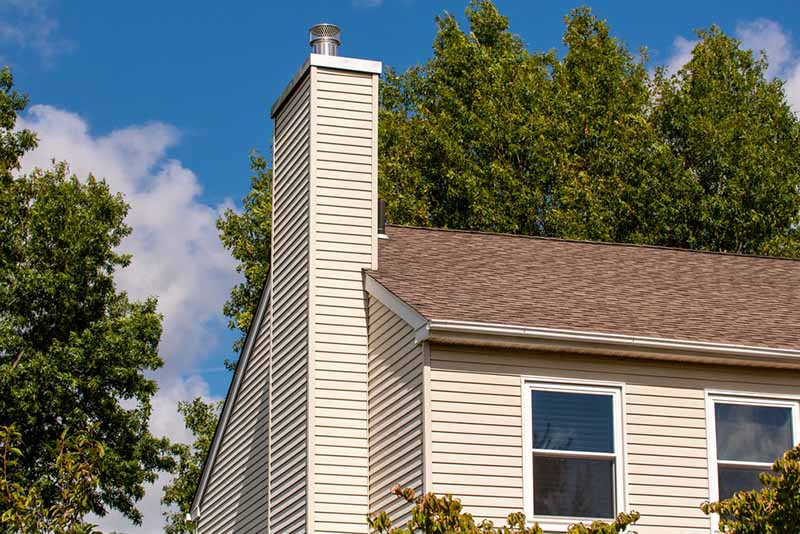 Top Hat & Tails Chimney - Stock image of chimney chimney with silver cap